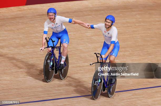Simone Consonni and Filippo Ganna of Team Italy celebrate after setting a new World record and winning a gold medal during the Men's team pursuit...