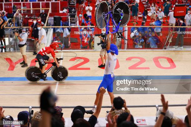 Filippo Ganna of Team Italy lifts his bike to celebrates winning a gold medal after setting a new World record during the Men's team pursuit finals,...