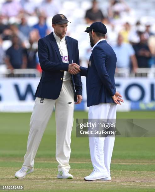 Captains Joe Root and Virat Kohli shake hands after the toss during day one of the First Test Match between England nd India at Trent Bridge on...