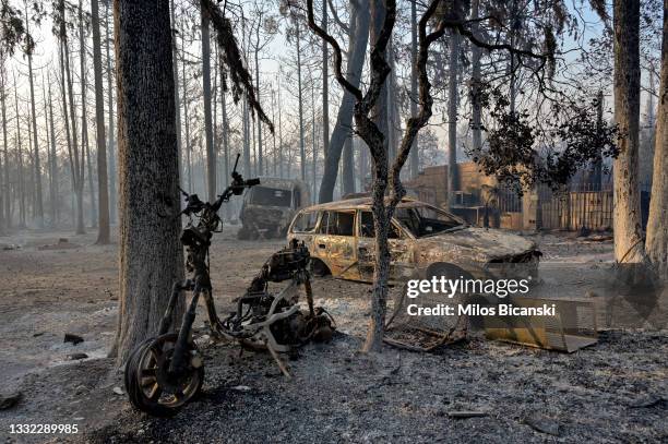 Burned cars and a residential house after a wildfire in northern Athens, on August 4, 2021 in Athens, Greece. People were evacuated from their homes...