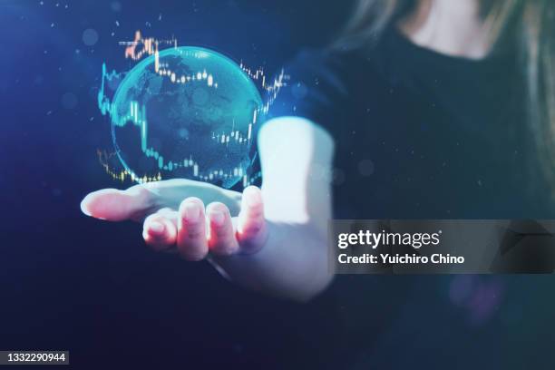 woman displaying global stock market - world bank stockfoto's en -beelden