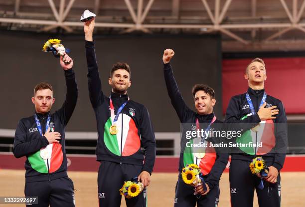 Gold medalist Simone Consonni, Filippo Ganna, Francesco Lamon and Jonathan Milan of Team Italy, pose on the podium during the medal ceremony after...