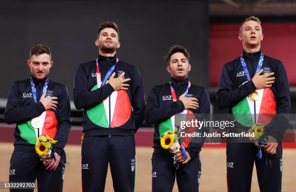 Gold medalist Simone Consonni, Filippo Ganna, Francesco Lamon and Jonathan Milan of Team Italy, pose on the podium during the medal ceremony after...