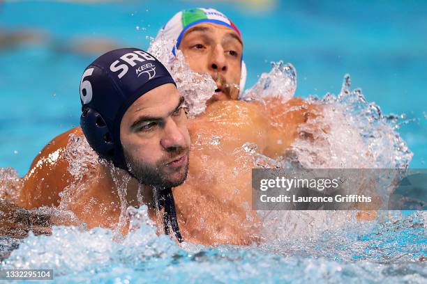 Dusko Pijetlovic of Team Serbia and Matteo Aicardi of Team Italy tussle during the Men's Quarterfinal match between Italy and Serbia on day twelve of...