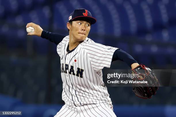 Yoshinobu Yamamoto of Team Japan pitches in the first inning against Team Republic of Korea during the semifinals of men's baseball on day twelve of...