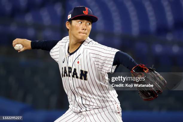 Yoshinobu Yamamoto of Team Japan pitches in the first inning against Team Republic of Korea during the semifinals of men's baseball on day twelve of...