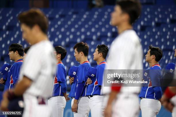 Team South Korea looks on during the national anthems prior to the game against Team Japan during the semifinals of men's baseball on day twelve of...