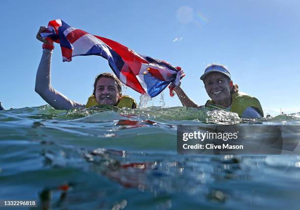 Hannah Mills and Eilidh McIntyre of Team Great Britain celebrate following the Women's 470 class medal race on day twelve of the Tokyo 2020 Olympic...