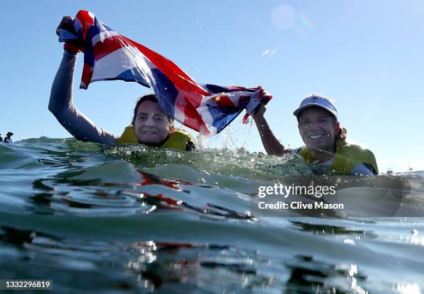 Hannah Mills and Eilidh McIntyre of Team Great Britain celebrate following the Women's 470 class medal race on day twelve of the Tokyo 2020 Olympic...