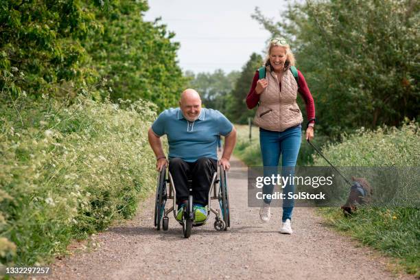 using my wheelchair on a dog walk - wheelchair stockfoto's en -beelden