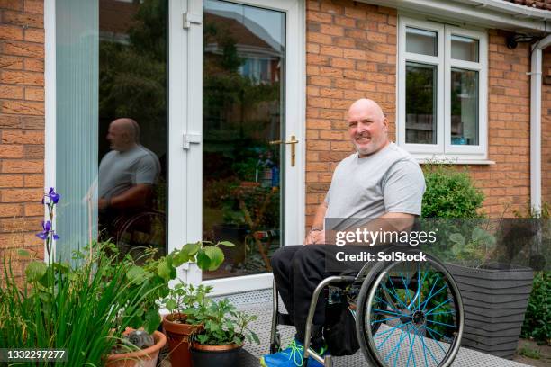 portrait of a man with disabilities outside his home - house with wheelchair ramp bildbanksfoton och bilder