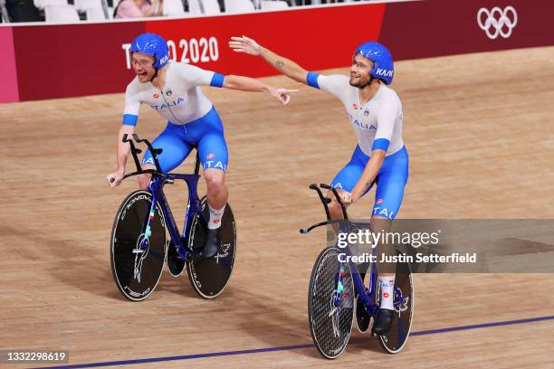 Simone Consonni and Filippo Ganna of Team Italy celebrate setting a new World record and winning a gold medal during the Men's team pursuit finals,...