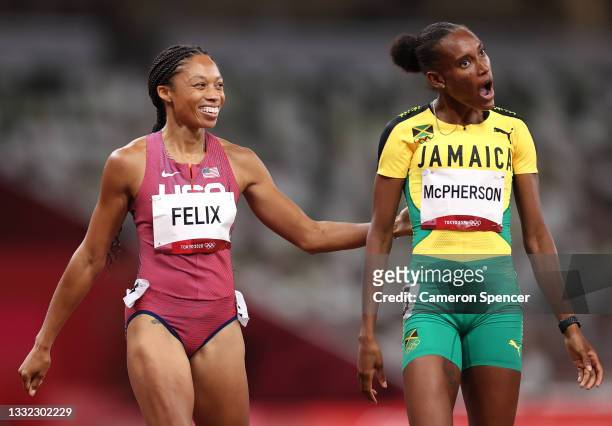 Allyson Felix of Team United States and Stephenie Ann McPherson of Team Jamaica interact after competing in the Women's 400m Semi-Final on day twelve...