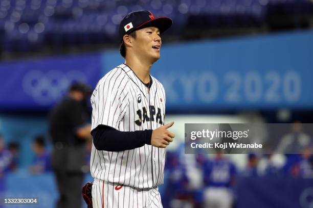 Yoshinobu Yamamoto of Team Japan reacts as he walks back to the dugout against Team Republic of Korea during the semifinals of men's baseball on day...