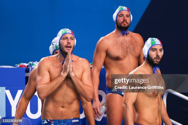 Niccolo Figari of Team Italy prays while teammate Stefano Luongo looks on during the Men's Quarterfinal match between Italy and Serbia on day twelve...