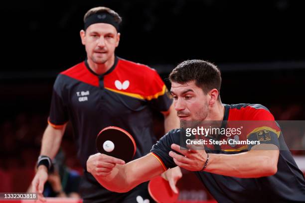 Timo Boll and Dimitrij Ovtcharov of Team Germany in action during their Men's Team Semifinals table tennis match on day twelve of the Tokyo 2020...