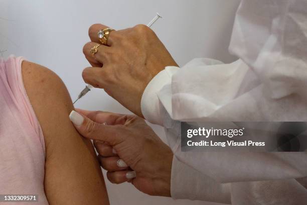 Woman gets a dose of the Moderna COVID-19 Vaccine as people from ages 25 to 30 start their vaccination phase with the Moderna novel COVID-19 vaccine...