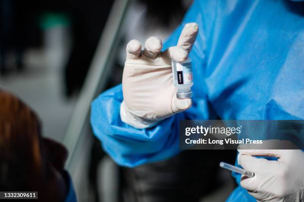 Nurse shows the vial of the Moderna novel Coronavirus vaccine as public transport drivers and people from ages 25 to 30 start their vaccination phase...