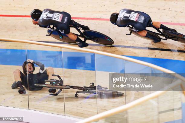 Campbell Stewart and Jordan Kerby of Team New Zealand sprint as Regan Gough of Team New Zealand falls during the Men's team pursuit finals, bronze...