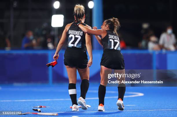 Maria Noel Barrionuevo and Rocio Sanchez Moccia of Team Argentina leave the pitch following victory in the Women's Semifinal match between Argentina...