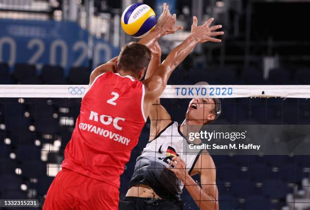 Oleg Stoyanovskiy of Team ROC competes against Julius Thole of Team Germany during the Men's Quarterfinal beach volleyball on day twelve of the Tokyo...