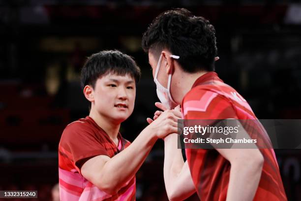 Harimoto Tomokazu of Team Japan shakes hands with his coach during his Men's Team Semifinals table tennis match on day twelve of the Tokyo 2020...