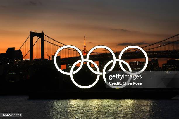 General view of the Olympic rings installation and Rainbow Bridge as the sun sets on day twelve of the Tokyo 2020 Olympic Games at Odaiba Marine Park...