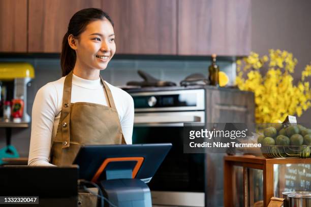 what would you like to coffee drink? young asian women waitress working inside the cashier counter. she enjoys serving their customers on busy days. keep a positive attitude at work concepts. point of sale system and customer service. - part time worker stock pictures, royalty-free photos & images