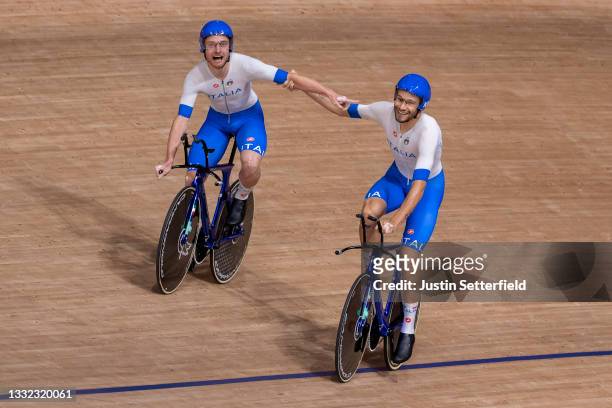 Simone Consonni and Filippo Ganna of Team Italy celebrate after setting a new World record and winning a gold medal during the Men's team pursuit...