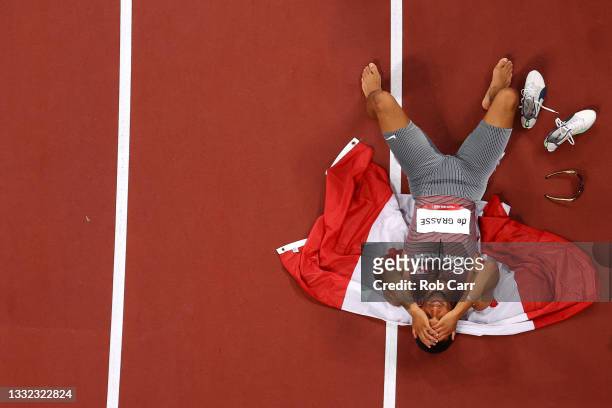 Andre De Grasse of Team Canada celebrates with his countries flag after winning the gold medal in the Men's 200m Final on day twelve of the Tokyo...