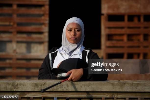 Khadijah Mellah, who last year became the first British Muslim woman jockey to ride in and win a competitive horse race, poses for a portrait with a...