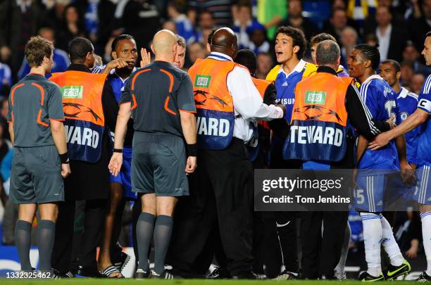 Chelsea players including Didier Drogba and head coach Gus Hiddink complain to the referee Tom Henning Ovrebo after the final whistle during the...