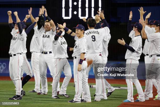 The Team Japan dugout reacts after Tetsuto Yamada of Team Japan hit a three-run double in the eighth inning against Team Republic of Korea during the...