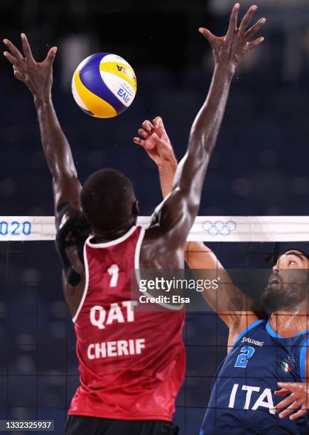 Cherif Younousse of Team Qatar competes against Daniele Lupo of Team Italy during the Men's Quarterfinal beach volleyball on day twelve of the Tokyo...