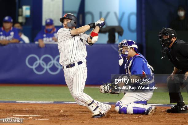 Tetsuto Yamada of Team Japan hits a three-run double in the eighth inning against Team Republic of Korea during the semifinals of men's baseball on...