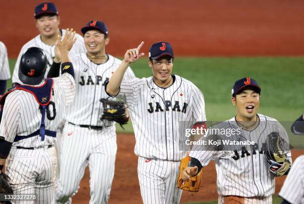 Tetsuto Yamada of Team Japan celebrates with his teammates after defeating Team Republic of Korea 5-2 during the semifinals of men's baseball on day...
