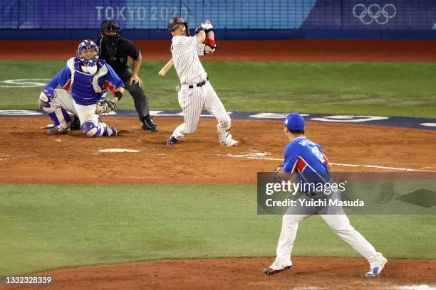 Tetsuto Yamada of Team Japan hits a three-run double in the eighth inning against Team Republic of Korea during the semifinals of men's baseball on...