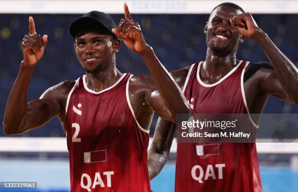 Cherif Younousse Ahmed Tijan of Team Qatar react after they defeated Team Italy during the Men's Quarterfinal beach volleyball on day twelve of the...