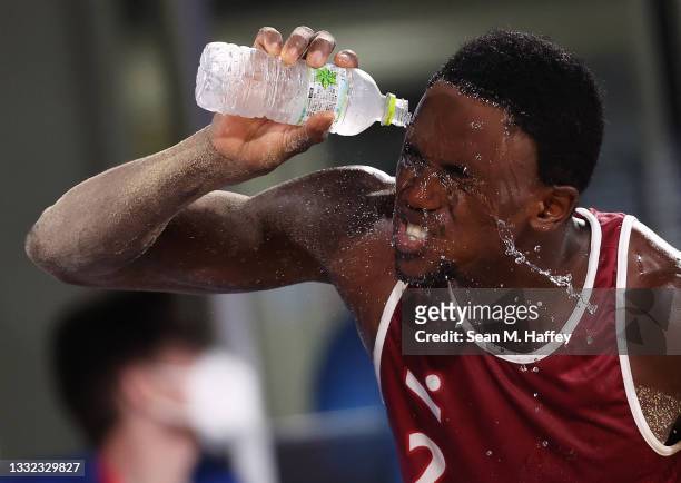Ahmed Tijan of Team Qatar pours water on his face as he competes against Team Italy during the Men's Quarterfinal beach volleyball on day twelve of...
