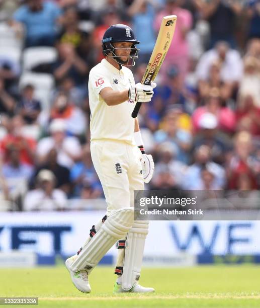 Joe Root of England raises his bat after scoring 50 runs during day one of the First Test Match between England and India at Trent Bridge on August...