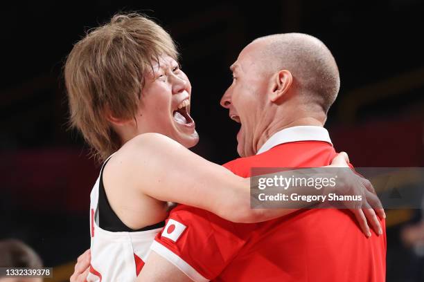 Maki Takada of Team Japan hugs Head Coach Tom Hovasse in celebration following Japan's win over Belgium in a Women's Basketball Quarterfinals game on...