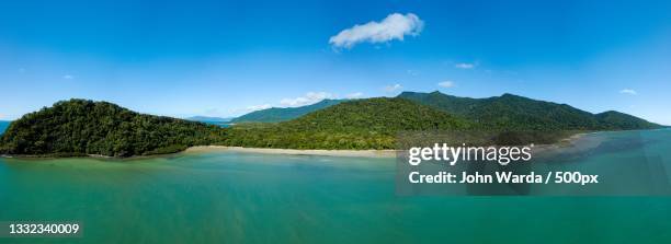 panoramic view of sea and mountains against blue sky,queensland,australia - country town australia stock pictures, royalty-free photos & images