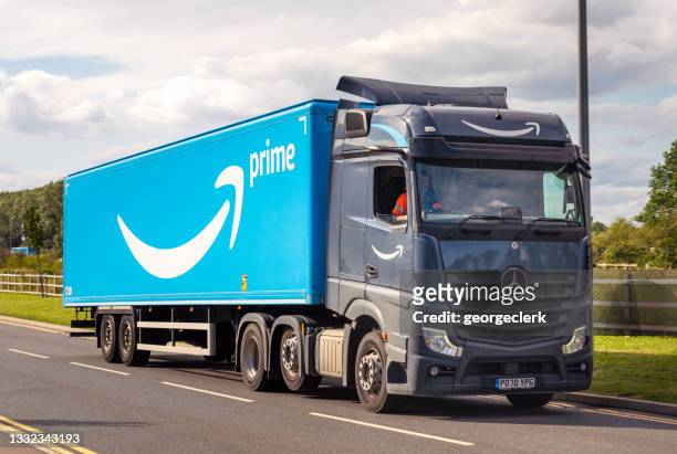 amazon prime delivery truck on the road - amazon boxes stock pictures, royalty-free photos & images