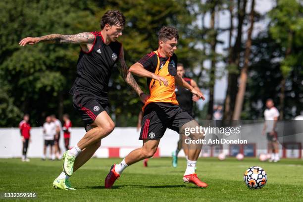 Victor Lindelof and Daniel James of Manchester United in action during a first team training session on August 04, 2021 in St Andrews, Scotland.