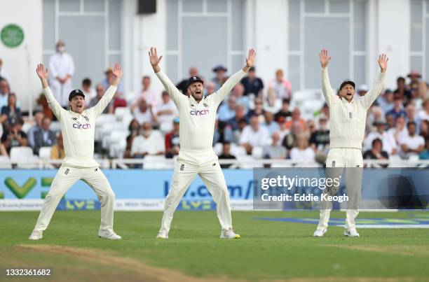 Rory Burns, Dom Sibley and captain Joe Root of England appeal for an lbw during day one of the First LV= Insurance test match between England and...