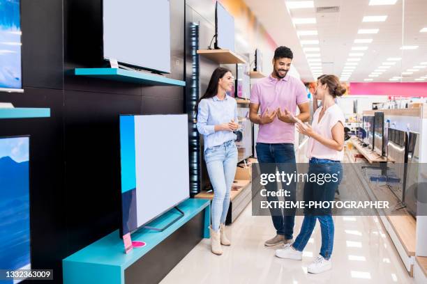 customer service during retail in a home appliances store - tv store stock pictures, royalty-free photos & images