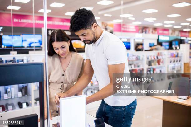 beautiful female customer receiving assistance - consumer electronics trade fair stock pictures, royalty-free photos & images