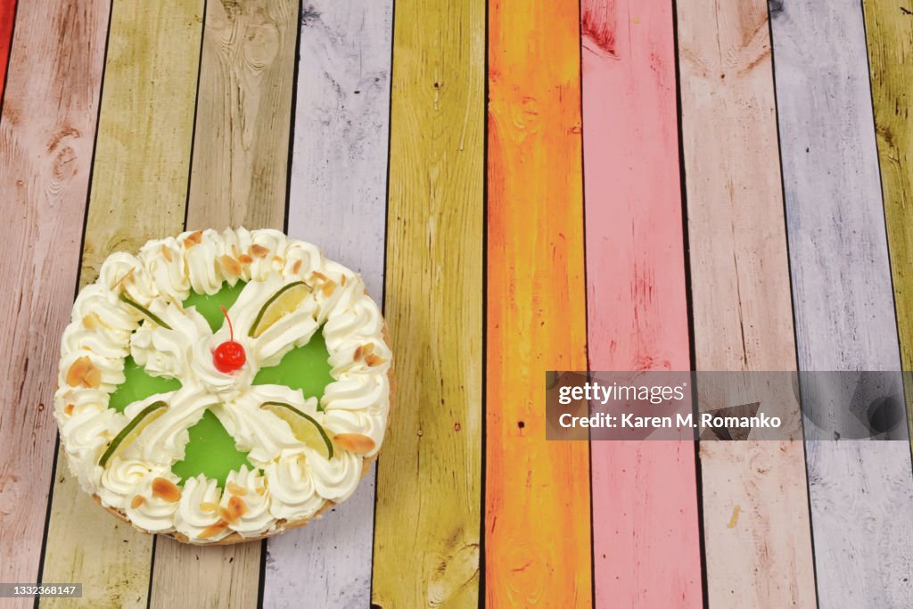 Key Lime Pie; Bottom Left on Colored Wood Background