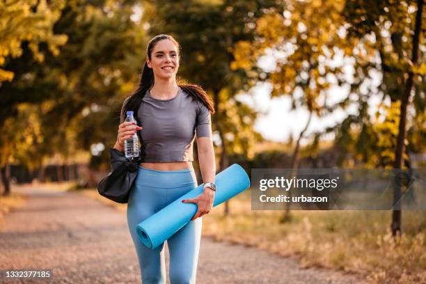 woman on her way to yoga class - mat stock pictures, royalty-free photos & images