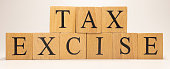 The name Excise tax was created from wooden letter cubes. Economics and finance.